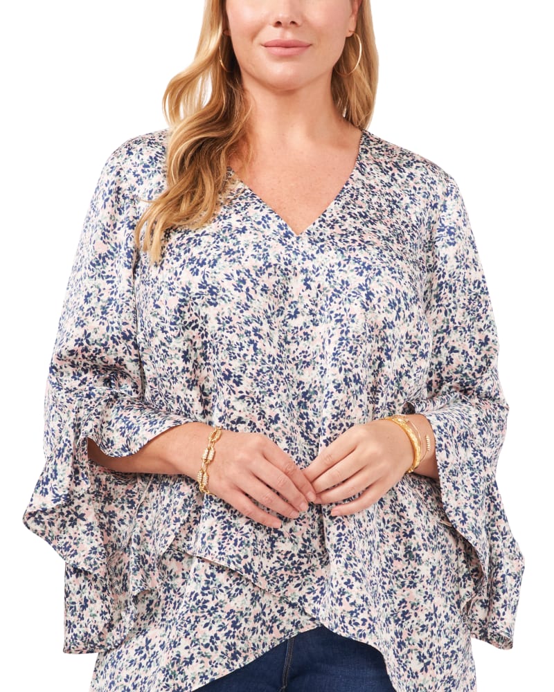 Front of a model wearing a size 1X Skylar Flutter Sleeve Tunic in FRESH PINK by Vince Camuto. | dia_product_style_image_id:261440